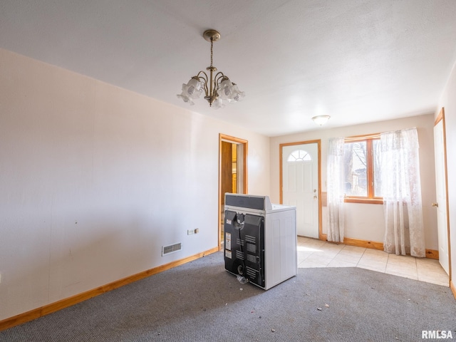 102 S Van Buren St, Lewistown, IL 61542 - unfurnished living room with baseboards, visible vents, a notable chandelier, and light carpet