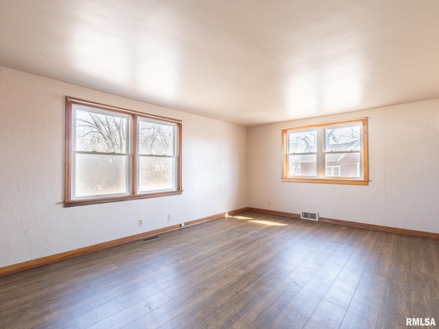 102 S Van Buren St, Lewistown, IL 61542 - empty room featuring baseboards, visible vents, and wood finished floors