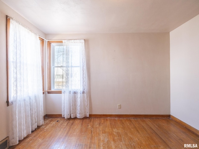 102 S Van Buren St, Lewistown, IL 61542 - empty room with baseboards, light wood finished floors, and visible vents