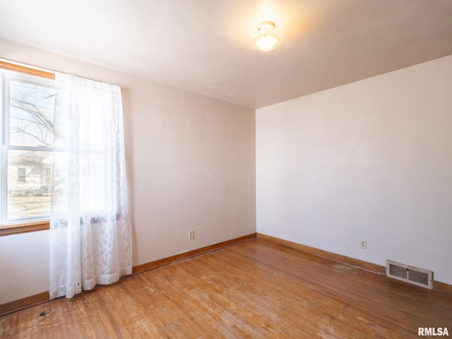 102 S Van Buren St, Lewistown, IL 61542 - spare room with plenty of natural light, baseboards, light wood-style floors, and visible vents