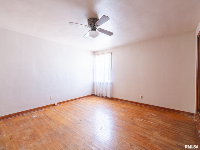 102 S Van Buren St, Lewistown, IL 61542 - unfurnished room with a ceiling fan, hardwood / wood-style flooring, and baseboards