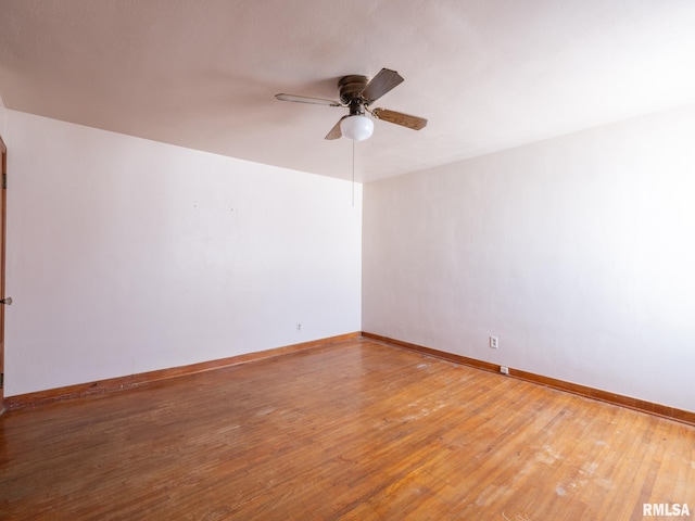102 S Van Buren St, Lewistown, IL 61542 - spare room with baseboards, a ceiling fan, and hardwood / wood-style flooring