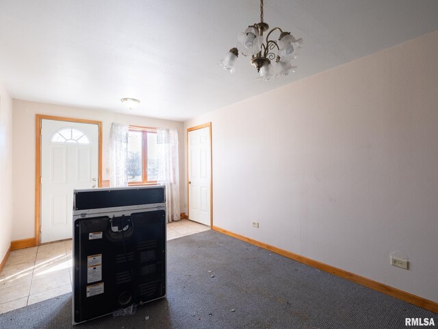 102 S Van Buren St, Lewistown, IL 61542 - living area featuring an inviting chandelier, tile patterned flooring, carpet flooring, and baseboards
