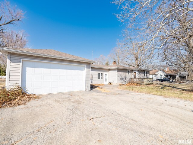 102 S Van Buren St, Lewistown, IL 61542 - single story home with a chimney and a garage