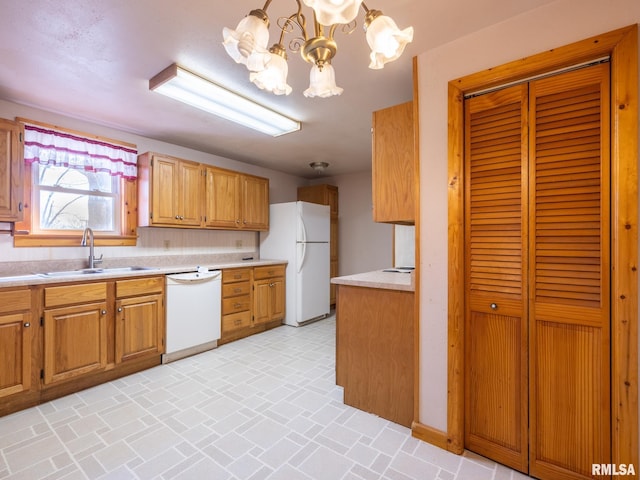 102 S Van Buren St, Lewistown, IL 61542 - kitchen with light countertops, white appliances, brick patterned floor, a sink, and a notable chandelier