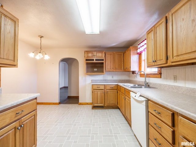 102 S Van Buren St, Lewistown, IL 61542 - kitchen with light countertops, a sink, dishwasher, baseboards, and arched walkways