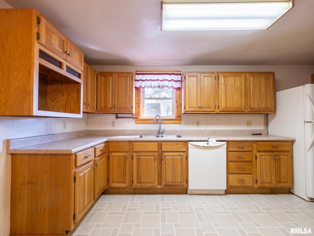 102 S Van Buren St, Lewistown, IL 61542 - kitchen featuring light countertops, a sink, brown cabinetry, and white appliances