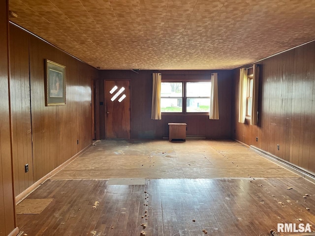 interior space featuring wooden walls and hardwood / wood-style floors