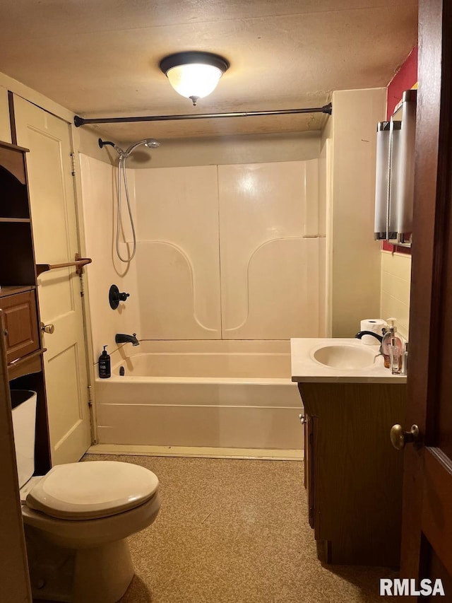 bathroom with toilet, vanity, and tub / shower combination