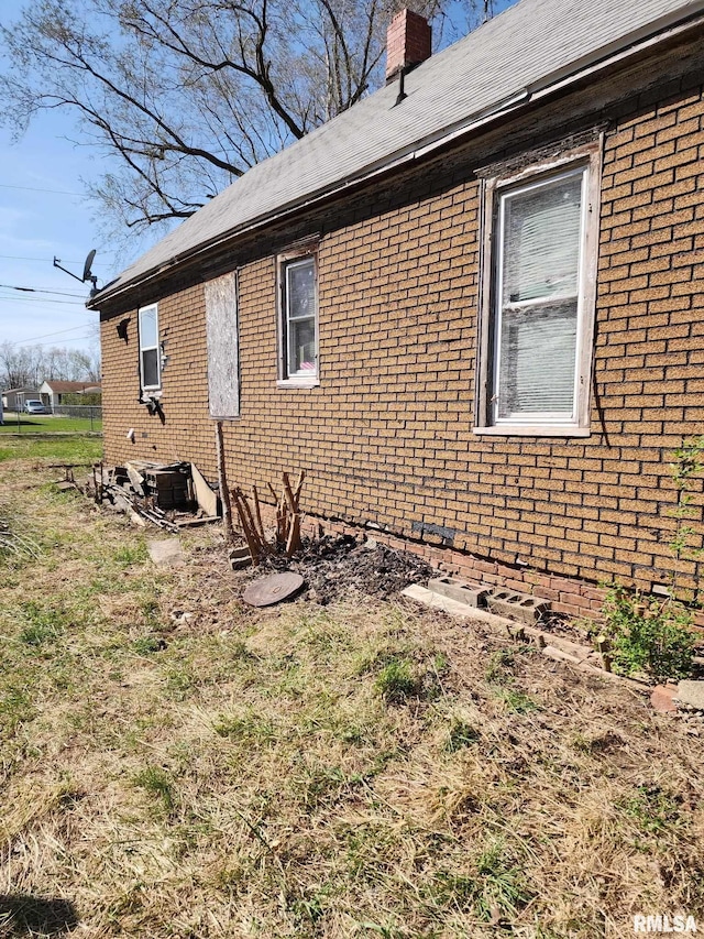 205 2nd St, South Pekin, IL 61564 - view of home's exterior with a chimney and brick siding