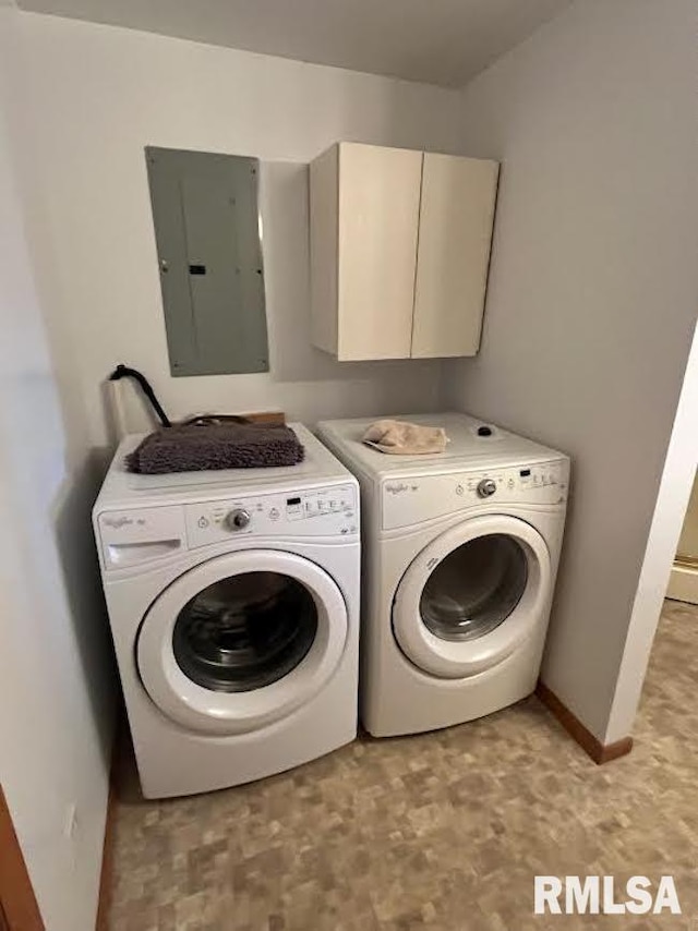 laundry area with electric panel, washing machine and clothes dryer, cabinet space, baseboards, and light flooring