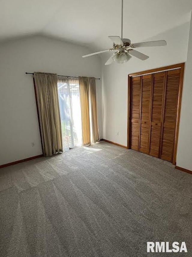 unfurnished bedroom with vaulted ceiling, baseboards, carpet floors, a closet, and ceiling fan