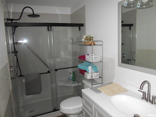 4 Hiel Dr, Bushnell, IL 61422 - bathroom with a shower stall, vanity, tile walls, and toilet