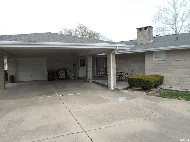 4 Hiel Dr, Bushnell, IL 61422 - view of property exterior featuring roof with shingles, a chimney, concrete driveway, and stone siding