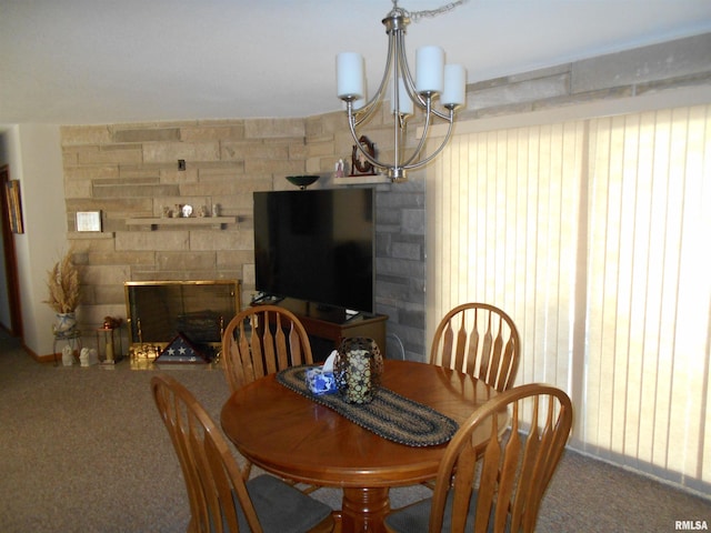 4 Hiel Dr, Bushnell, IL 61422 - carpeted dining room featuring a stone fireplace and an inviting chandelier