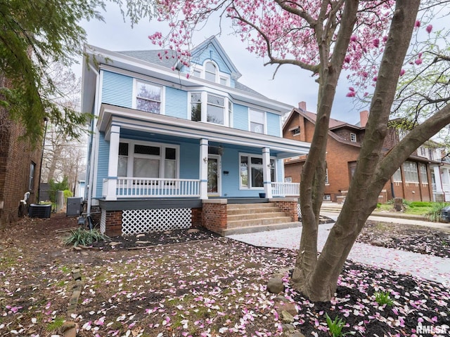 943 NE Glen Oak Ave, Peoria, IL 61603 - victorian house featuring central air condition unit and covered porch