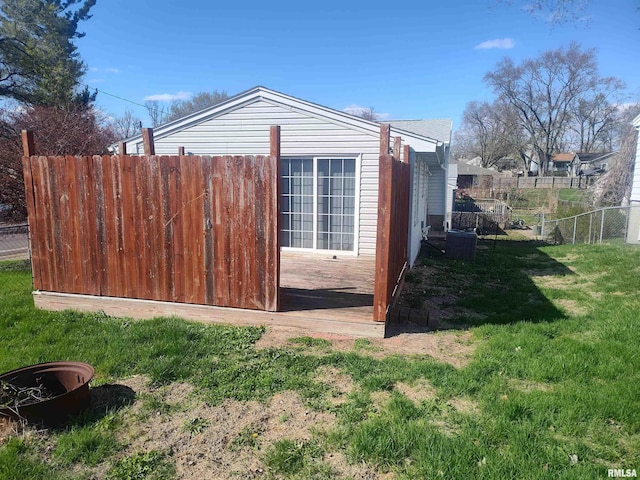 view of property exterior featuring a yard and fence