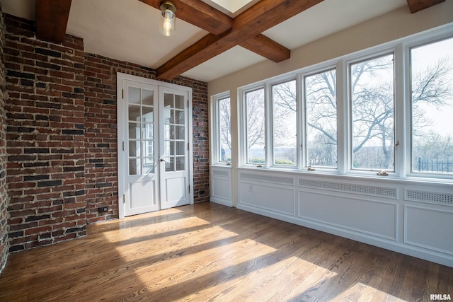 unfurnished sunroom featuring french doors and beamed ceiling