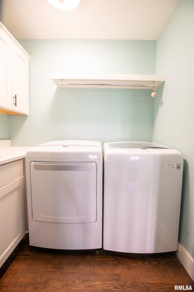 laundry area featuring cabinet space, separate washer and dryer, and dark wood-style floors
