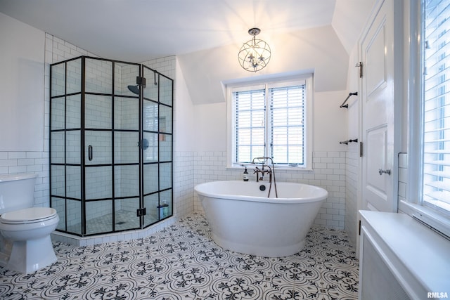 bathroom with a shower stall, tile patterned floors, and tile walls