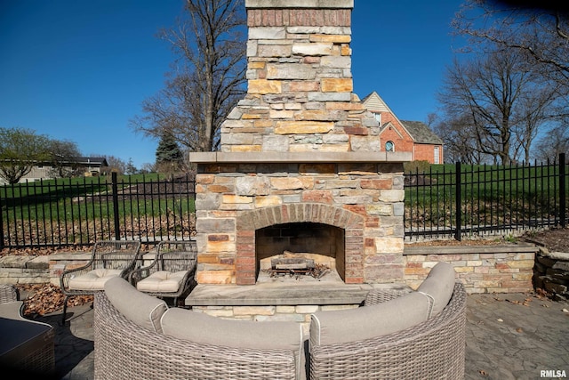 view of patio featuring an outdoor living space with a fireplace and fence