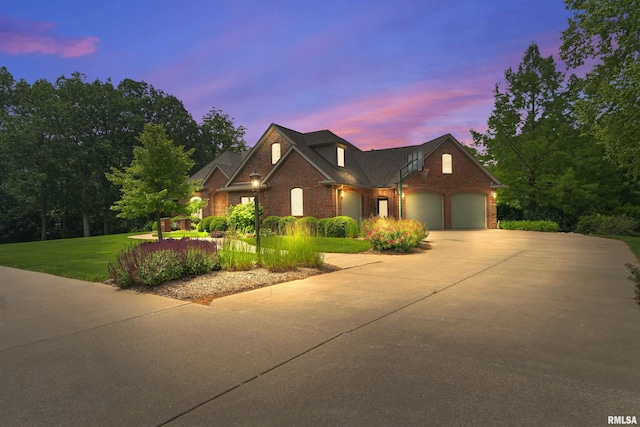 1801 Kern Rd, Washington, IL 61571 - traditional-style house featuring brick siding, a garage, concrete driveway, and a lawn