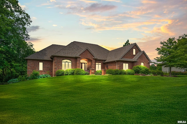 1801 Kern Rd, Washington, IL 61571 - french country style house featuring brick siding, a front yard, and a shingled roof