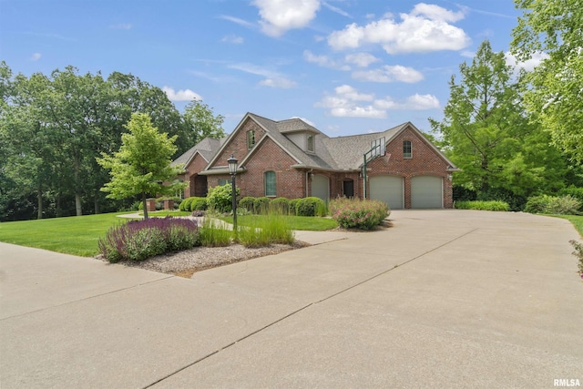 1801 Kern Rd, Washington, IL 61571 - traditional-style house with brick siding, concrete driveway, a garage, and a front yard