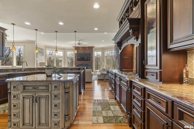 1801 Kern Rd, Washington, IL 61571 - kitchen featuring a sink, light wood-style flooring, healthy amount of natural light, recessed lighting, and ornamental molding