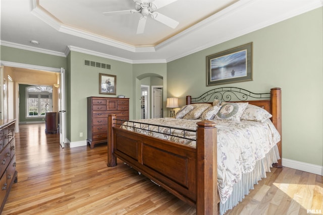 1801 Kern Rd, Washington, IL 61571 - bedroom with a raised ceiling, arched walkways, light wood finished floors, ornamental molding, and baseboards
