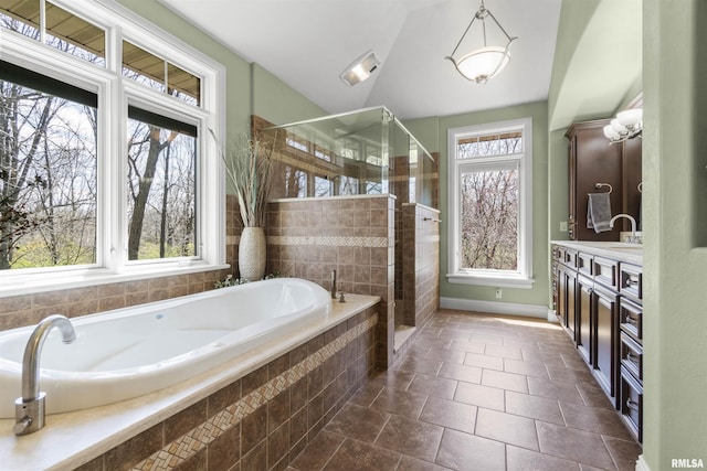 1801 Kern Rd, Washington, IL 61571 - bathroom featuring plenty of natural light, a garden tub, a stall shower, vanity, and vaulted ceiling