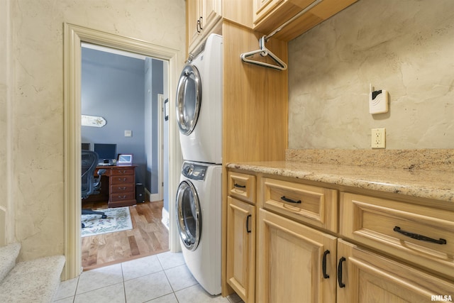 1801 Kern Rd, Washington, IL 61571 - washroom with stacked washer / dryer, cabinet space, light tile patterned floors, and an office area