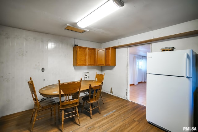 dining area featuring attic access and wood finished floors