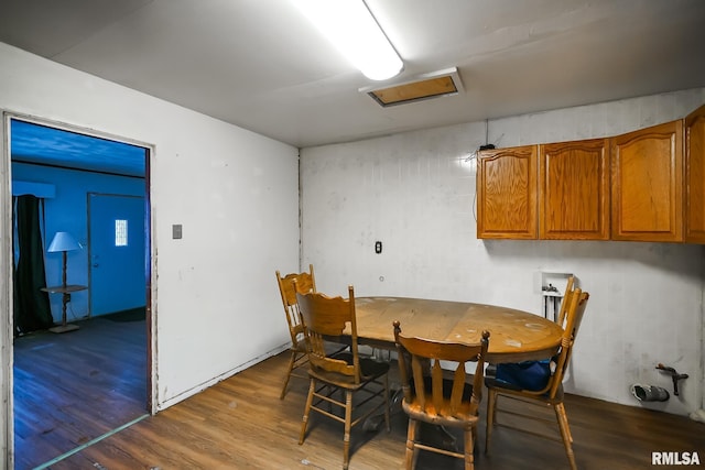 dining area featuring attic access and wood finished floors