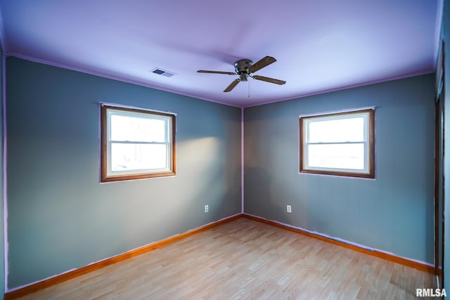 spare room featuring visible vents, baseboards, and a healthy amount of sunlight