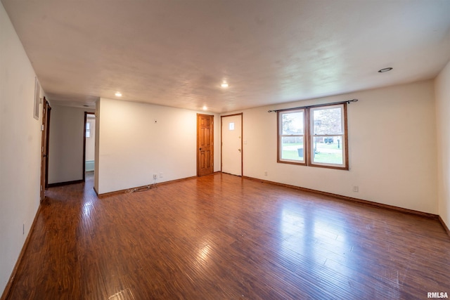 unfurnished room with baseboards, recessed lighting, and wood finished floors