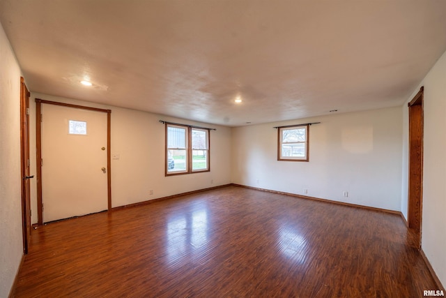 empty room featuring baseboards and wood finished floors