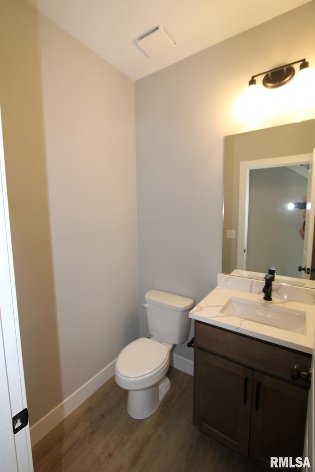 106 Samuel Ct, Washington, IL 61571 - bathroom featuring toilet, vanity, wood finished floors, and baseboards