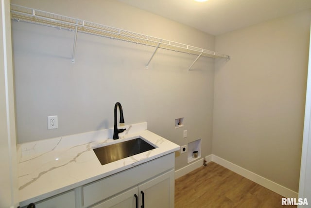 106 Samuel Ct, Washington, IL 61571 - laundry area featuring hookup for a washing machine, electric dryer hookup, light wood-style flooring, cabinet space, and baseboards