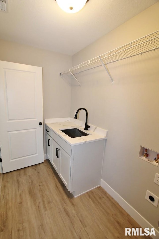 106 Samuel Ct, Washington, IL 61571 - laundry room with electric dryer hookup, light wood finished floors, cabinet space, and baseboards