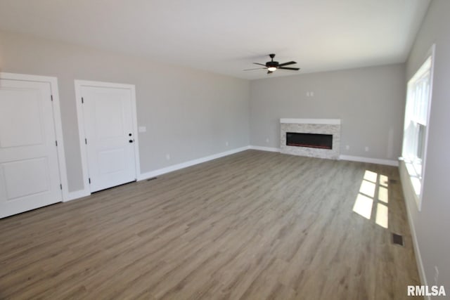 106 Samuel Ct, Washington, IL 61571 - unfurnished living room with wood finished floors, baseboards, and ceiling fan