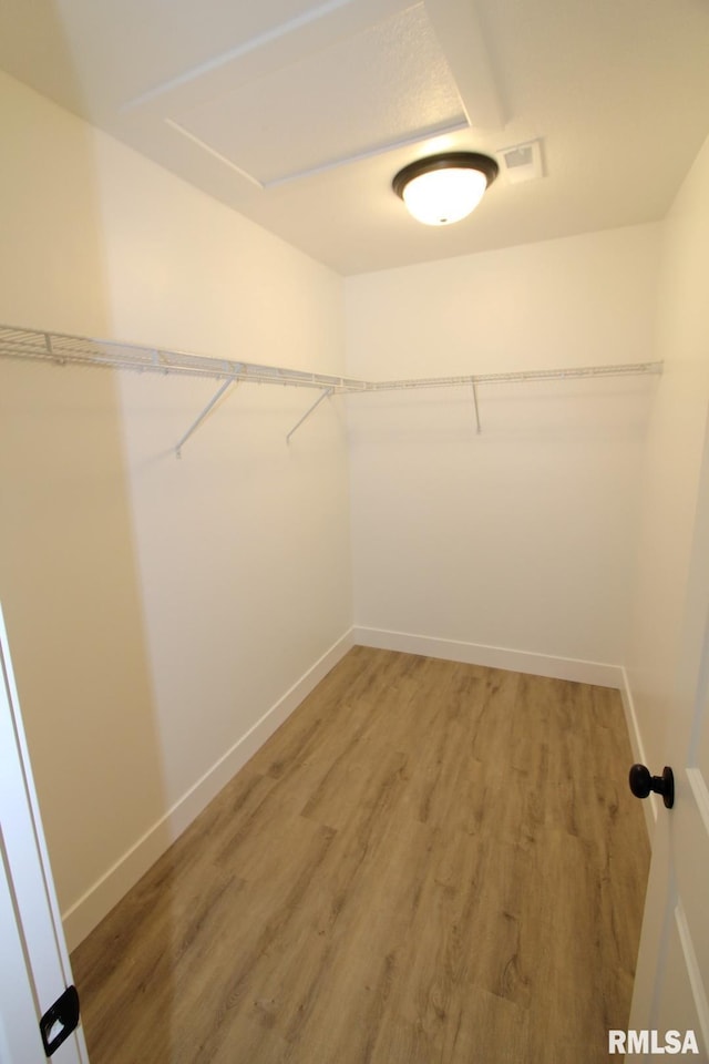 106 Samuel Ct, Washington, IL 61571 - walk in closet featuring attic access and light wood-style floors