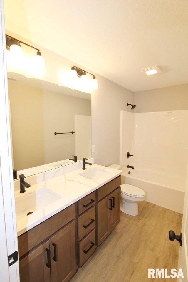 106 Samuel Ct, Washington, IL 61571 - full bathroom featuring double vanity, wood finished floors, toilet, and  shower combination