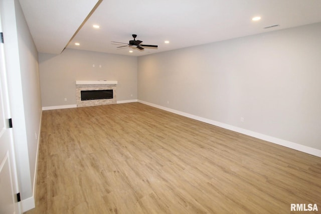 106 Samuel Ct, Washington, IL 61571 - unfurnished living room with recessed lighting, light wood-style floors, a ceiling fan, baseboards, and a glass covered fireplace