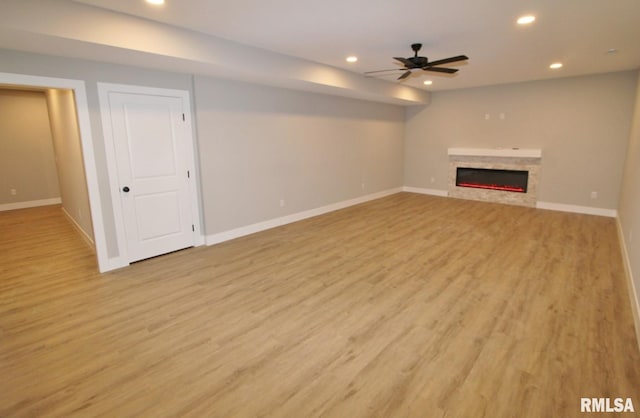 106 Samuel Ct, Washington, IL 61571 - unfurnished living room featuring recessed lighting, baseboards, light wood-style floors, and a glass covered fireplace