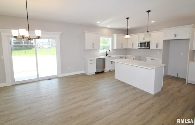 106 Samuel Ct, Washington, IL 61571 - kitchen with appliances with stainless steel finishes, a center island, light wood-type flooring, a chandelier, and recessed lighting