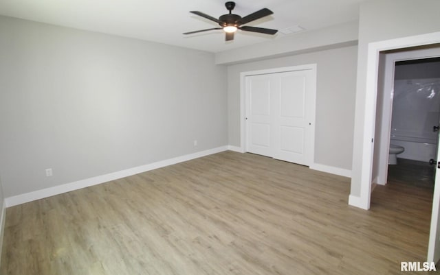 106 Samuel Ct, Washington, IL 61571 - unfurnished bedroom featuring wood finished floors, baseboards, a closet, and ceiling fan