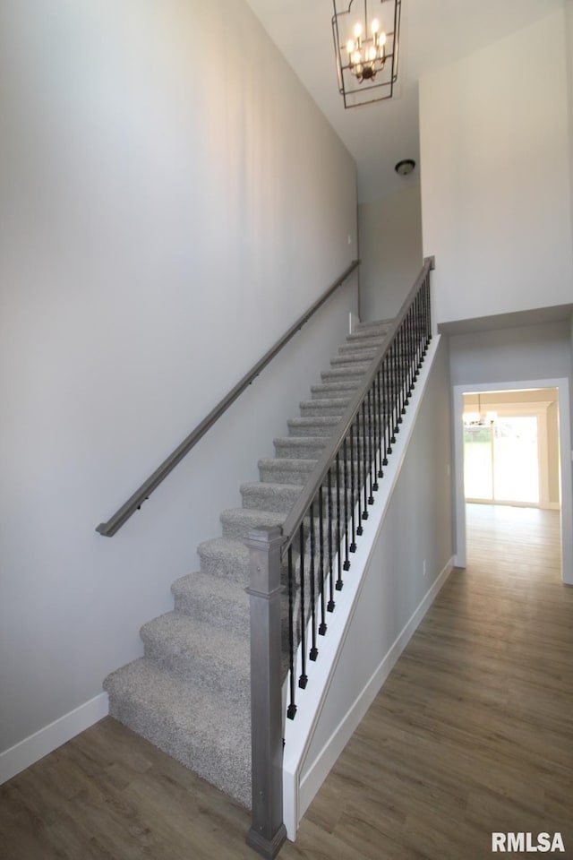 106 Samuel Ct, Washington, IL 61571 - stairway featuring a chandelier, wood finished floors, baseboards, and a high ceiling