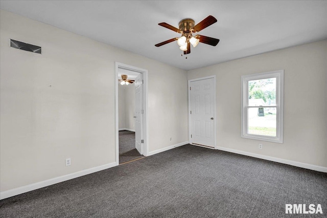 420 S Western Ave, Abingdon, IL 61410 - unfurnished bedroom with dark colored carpet, baseboards, and a ceiling fan
