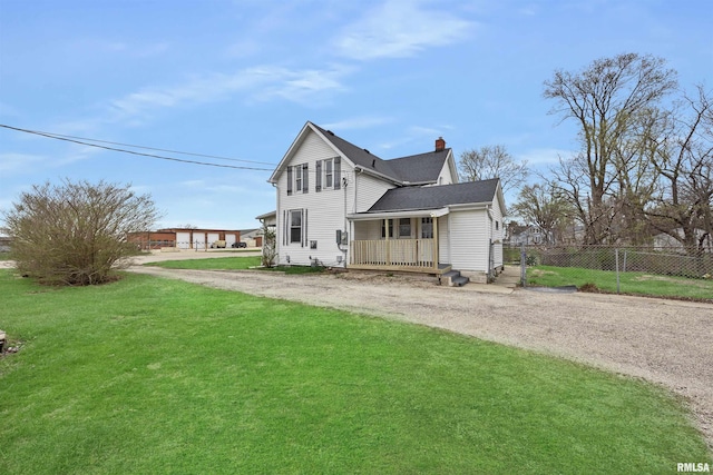 2330 S Airport Rd, Bartonville, IL 61607 - view of side of property with a porch, a lawn, a chimney, dirt driveway, and fence